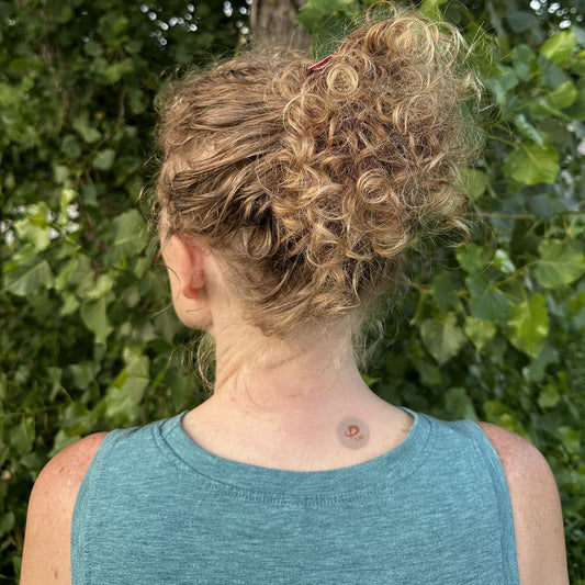 Xalara Glow patch applied to the back of the neck, showing placement site